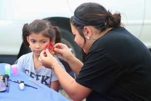 Kylie painting faces at Connors Fall Festival. 